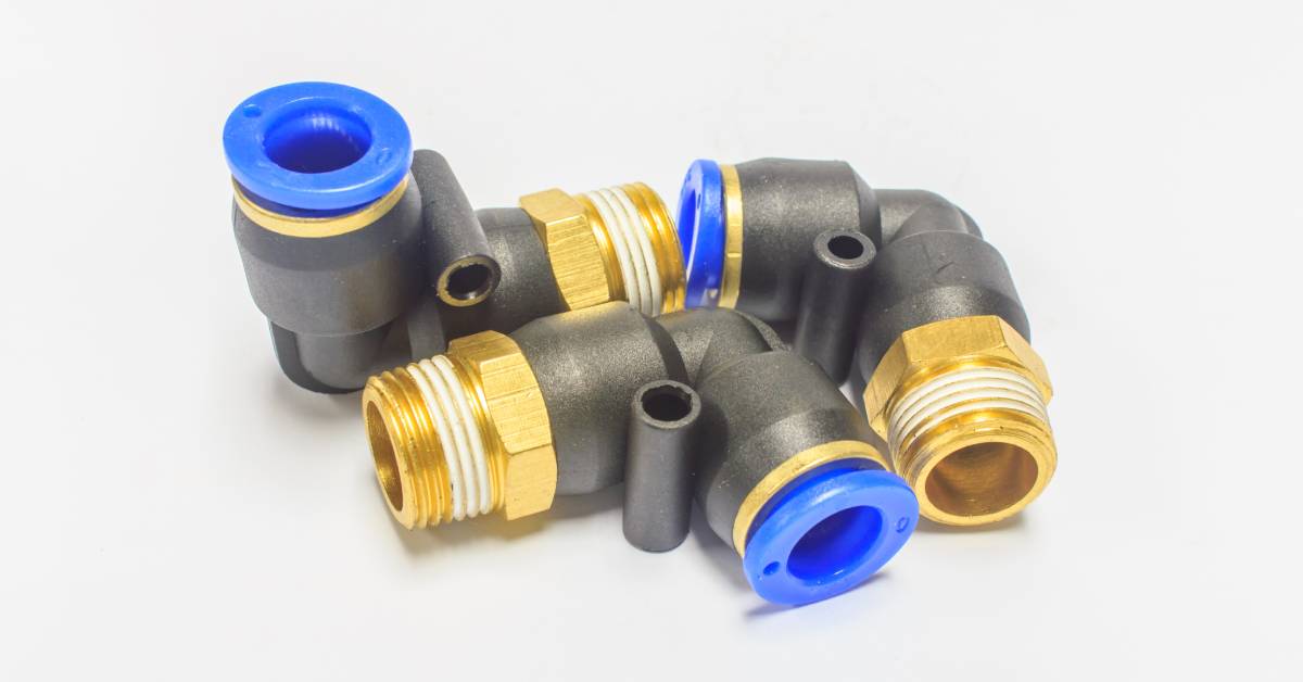 Three pipe connectors with black bases and gold threads. There are blue plastic plugs attached to one end of each connector.